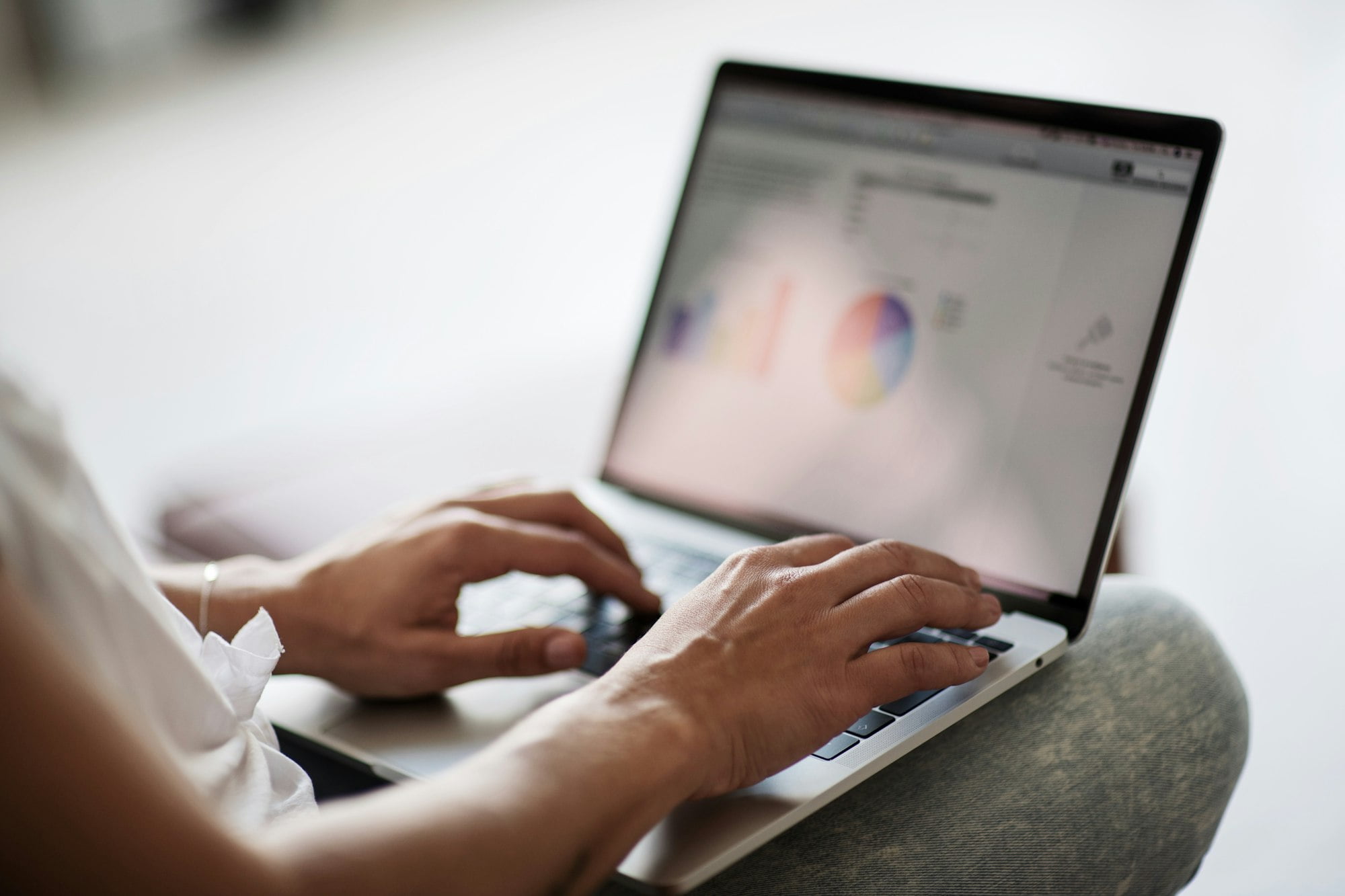 Millennial candid authentic girl using laptop for income e-commerce business at home